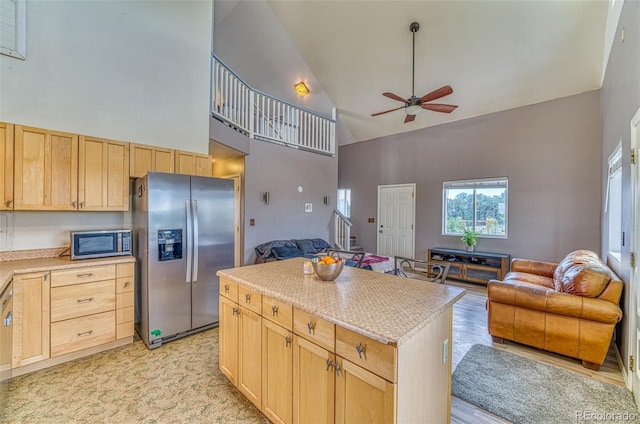 21540 Ridgeline Dr S, Trinidad, CO 81082 - kitchen featuring appliances with stainless steel finishes, high vaulted ceiling, light brown cabinets, open floor plan, and a ceiling fan
