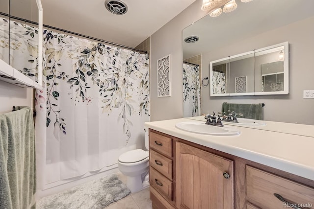 bathroom with tile patterned floors, vanity, and toilet