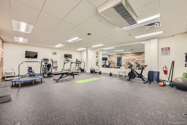 exercise room with a paneled ceiling