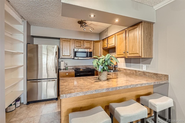 1850 Folsom St Unit 402, Boulder, CO 80302 - kitchen featuring stainless steel appliances, a textured ceiling, a breakfast bar area, a peninsula, and open shelves
