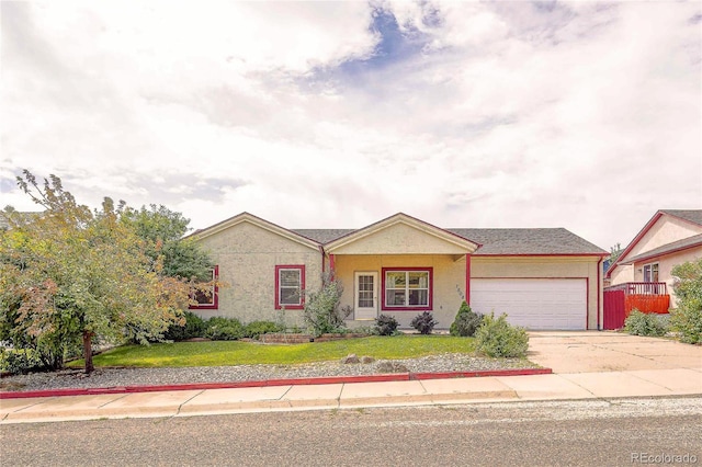 ranch-style home with a front lawn and a garage