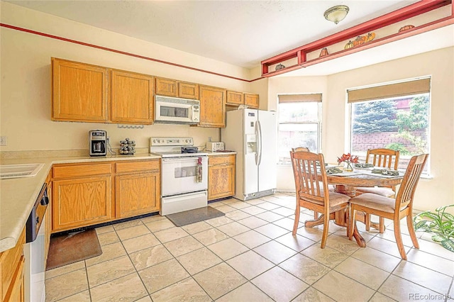 kitchen with white appliances and light tile patterned flooring