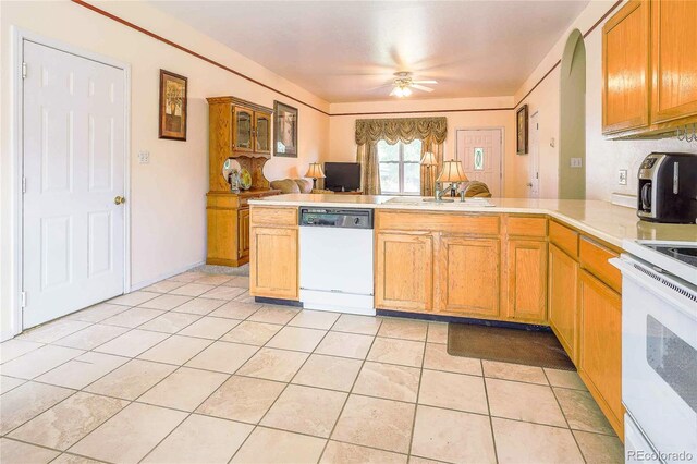 kitchen with light tile patterned floors, white dishwasher, ceiling fan, range, and kitchen peninsula