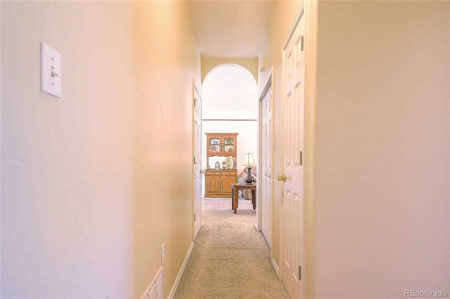 corridor with light colored carpet