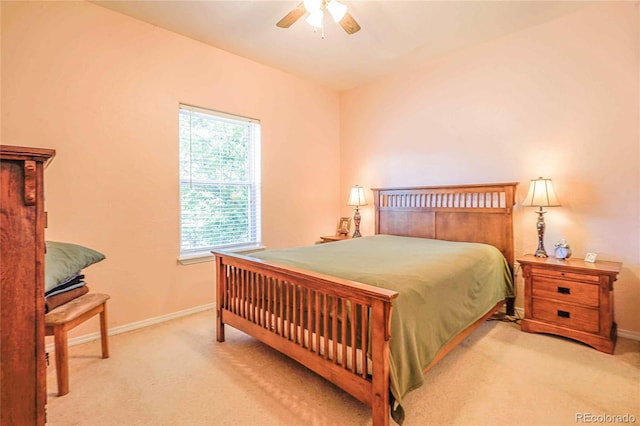 bedroom with ceiling fan, lofted ceiling, and light carpet