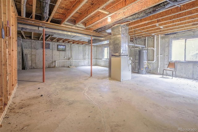 basement featuring water heater and heating unit