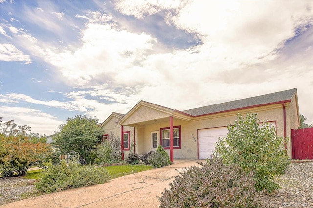 1508 Atchison Ave, Trinidad, CO 81082 - view of front of house featuring a garage, stucco siding, and driveway