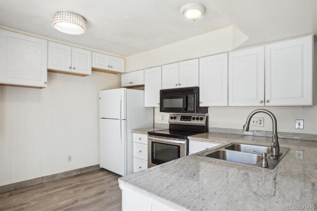 2453 S Xanadu Way Unit C, Aurora, CO 80014 - kitchen with electric stove, black microwave, freestanding refrigerator, white cabinetry, and light wood-style flooring