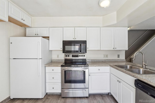 2453 S Xanadu Way Unit C, Aurora, CO 80014 - kitchen with appliances with stainless steel finishes, wood finished floors, and white cabinetry