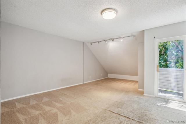 2453 S Xanadu Way Unit C, Aurora, CO 80014 - carpeted empty room featuring a textured ceiling and track lighting