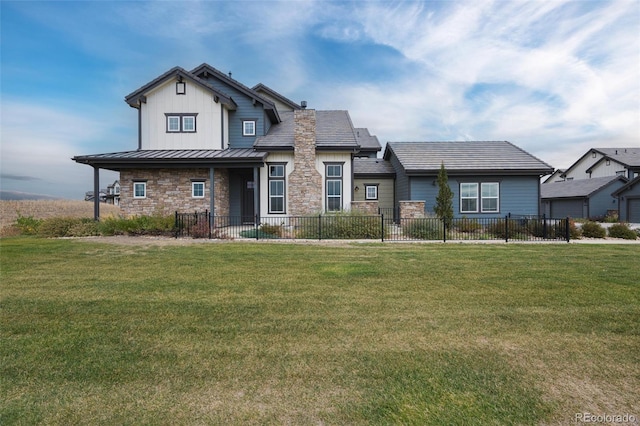 view of front of home with a standing seam roof, a fenced front yard, stone siding, and metal roof