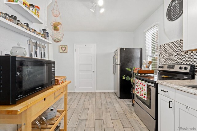 kitchen featuring open shelves, stainless steel appliances, decorative backsplash, white cabinetry, and light wood-type flooring