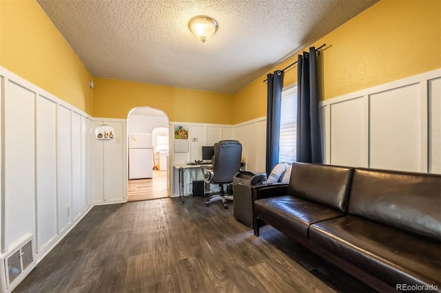 office featuring dark hardwood / wood-style flooring and a textured ceiling