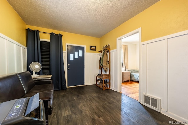 entryway with a textured ceiling and dark hardwood / wood-style floors