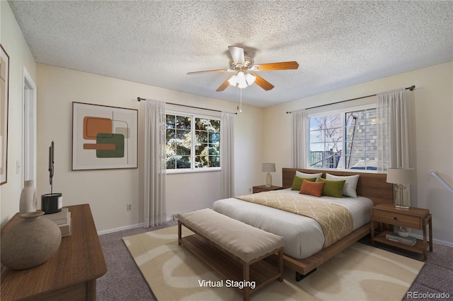 bedroom featuring carpet, baseboards, ceiling fan, and a textured ceiling