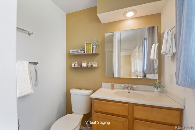 bathroom with toilet and vanity