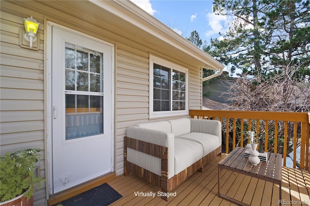 wooden deck with an outdoor living space