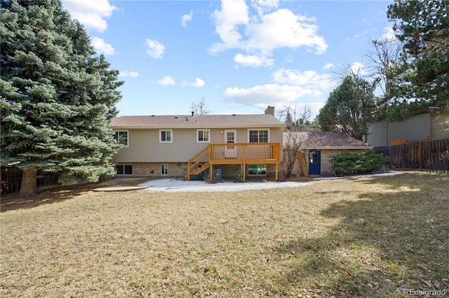 rear view of house with a lawn, a patio, a chimney, stairway, and fence