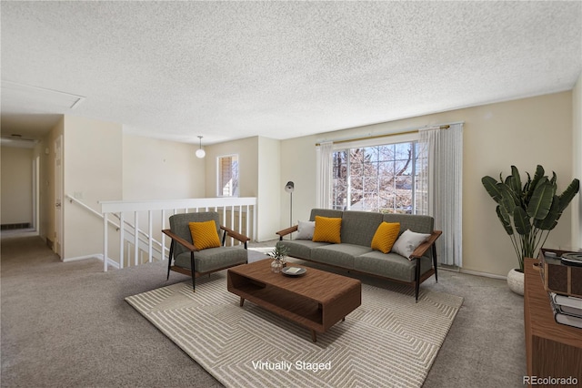 carpeted living room featuring a textured ceiling and baseboards