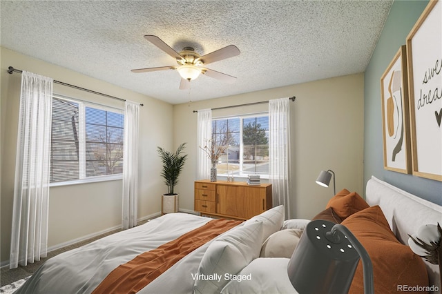 bedroom with a textured ceiling, a ceiling fan, and baseboards