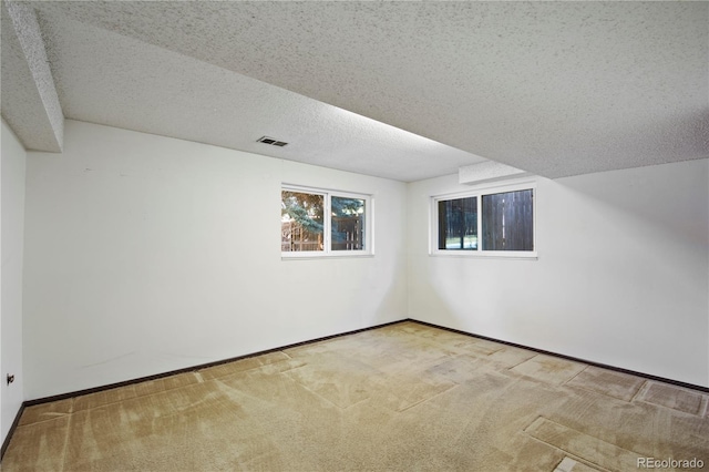 bonus room featuring baseboards, visible vents, a textured ceiling, and carpet flooring