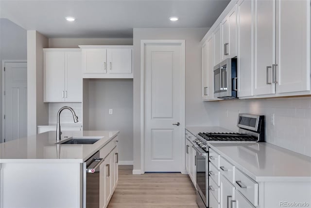 13398 E 99th Pl, Commerce City, CO 80022 - kitchen with stainless steel appliances, a sink, light wood-type flooring, tasteful backsplash, and white cabinetry