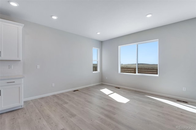 13398 E 99th Pl, Commerce City, CO 80022 - unfurnished room with light wood finished floors, baseboards, and recessed lighting