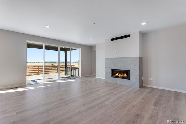 13398 E 99th Pl, Commerce City, CO 80022 - unfurnished living room featuring wood finished floors, a fireplace, recessed lighting, and baseboards