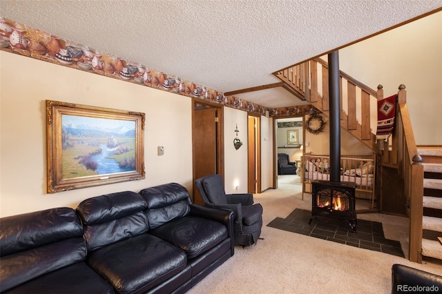 carpeted living room featuring a wood stove and a textured ceiling