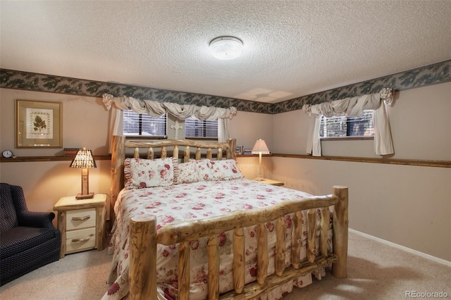 bedroom featuring multiple windows, light colored carpet, and a textured ceiling