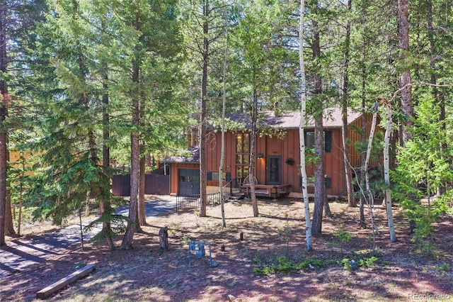 1321 W Midland Ave, Woodland Park, CO 80863 - rear view of property with board and batten siding and fence
