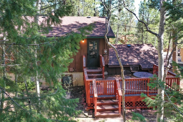 1321 W Midland Ave, Woodland Park, CO 80863 - view of front facade with roof with shingles and a wooden deck