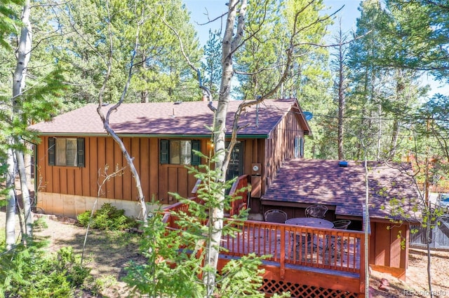 1321 W Midland Ave, Woodland Park, CO 80863 - view of front of property with board and batten siding, a shingled roof, and a deck