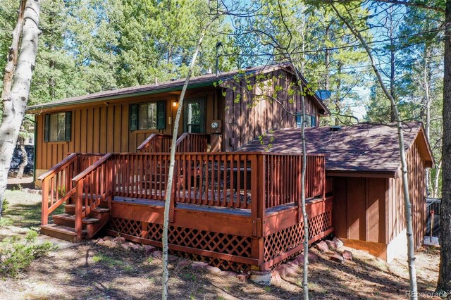 1321 W Midland Ave, Woodland Park, CO 80863 - rear view of house with a deck, roof with shingles, and board and batten siding