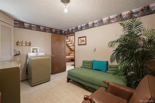 1321 W Midland Ave, Woodland Park, CO 80863 - living room with a textured ceiling, stairs, light tile patterned flooring, and washing machine and dryer