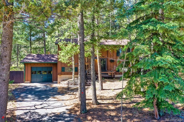 1321 W Midland Ave, Woodland Park, CO 80863 - chalet / cabin with fence, driveway, and a shingled roof