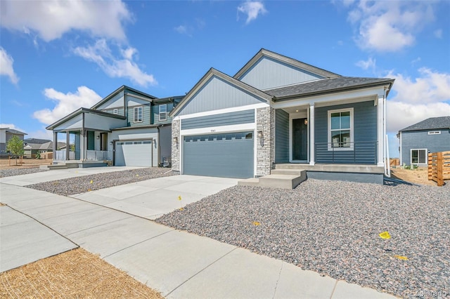 9343 Biscay St, Commerce City, CO 80022 - craftsman-style home featuring concrete driveway, stone siding, covered porch, and a garage