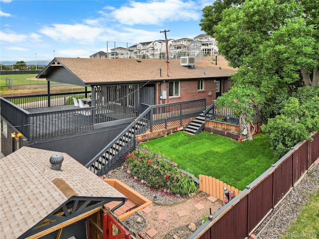 8079 W 67th Ave, Arvada, CO 80004 - back of property featuring a deck, a fenced backyard, stairway, roof with shingles, and brick siding
