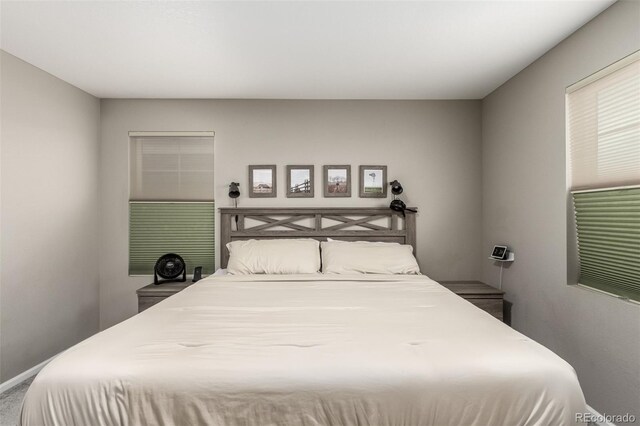 bedroom featuring dark colored carpet