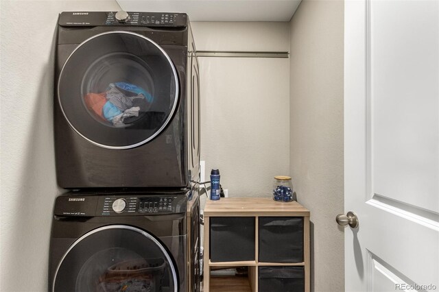 laundry area featuring stacked washer and clothes dryer