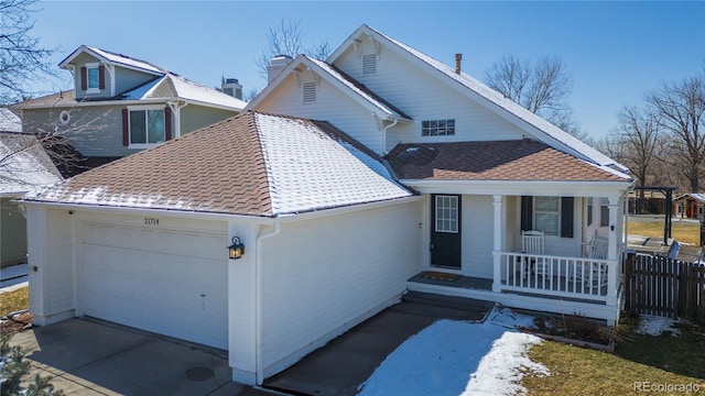 view of front of home with a shingled roof, a porch, concrete driveway, a chimney, and a garage