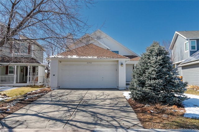 view of front of house featuring covered porch, a garage, and driveway