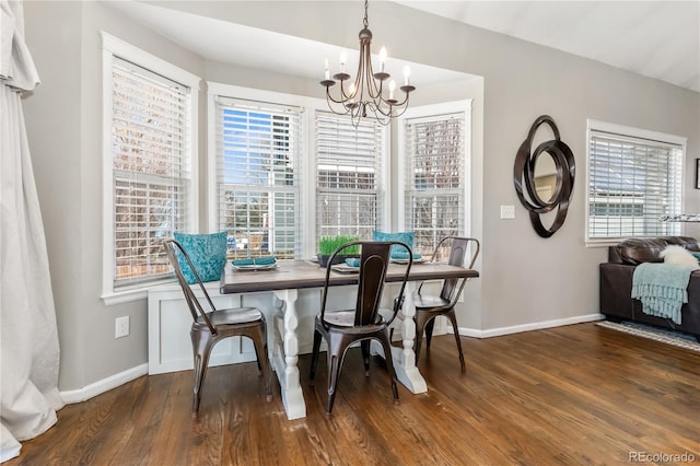 dining space with wood finished floors, baseboards, and a chandelier