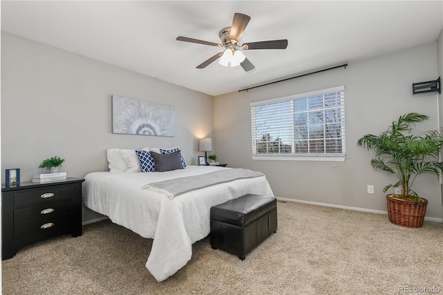 bedroom featuring ceiling fan, baseboards, and light carpet