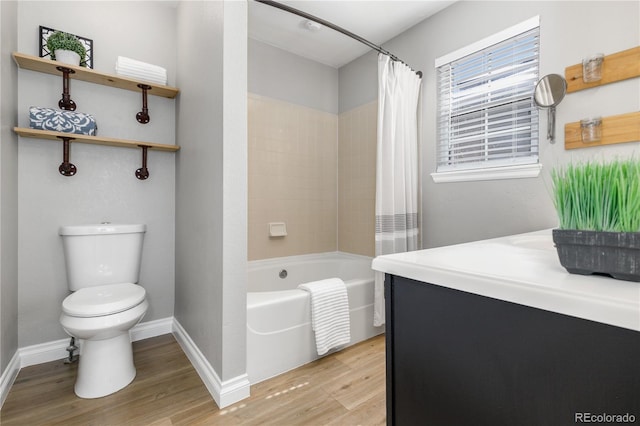 full bathroom with toilet, shower / tub combo, baseboards, and wood finished floors