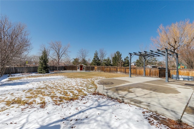 yard layered in snow with a pergola and a fenced backyard