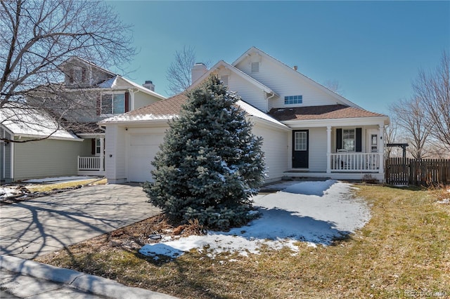 view of front of property featuring a garage, a porch, driveway, and fence