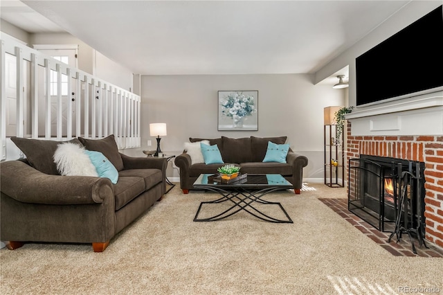 carpeted living room featuring a brick fireplace and baseboards