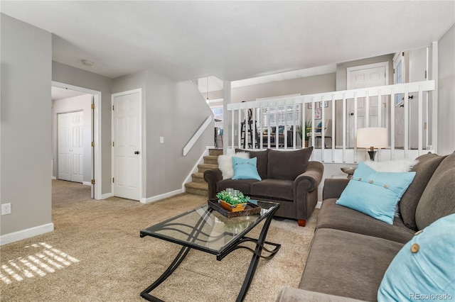 living room featuring stairway, baseboards, and carpet floors