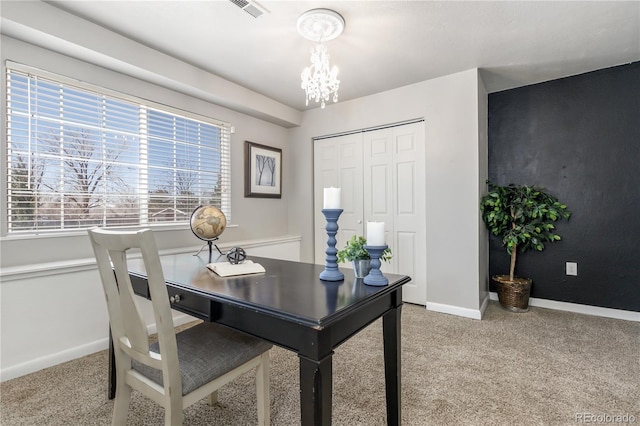 office featuring light carpet, a chandelier, baseboards, and visible vents